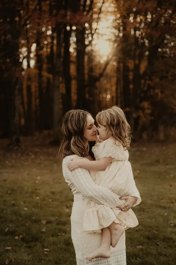 One of the founder's daughters holding her little sister in golden autumn light