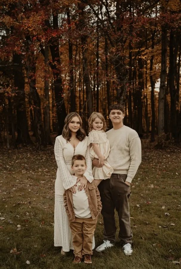 Lyndsay Sunderlin's four children together in an autumn forest