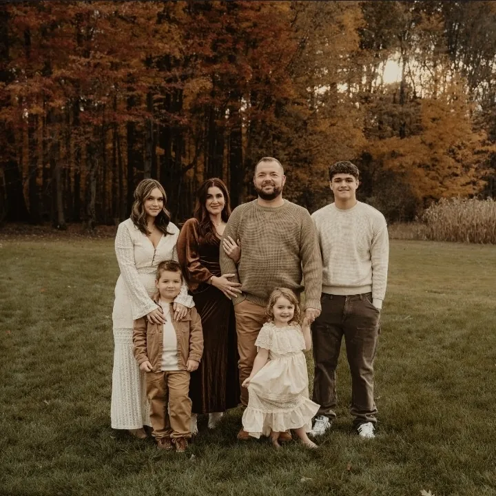 Lyndsay Sunderlin with her husband and four children in an autumn field
